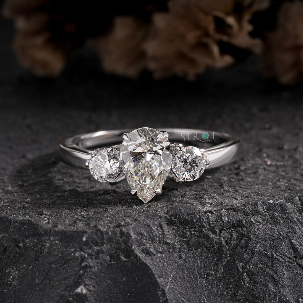 Elegant Pear and Round Three-Stone Diamond Engagement Ring in White Gold