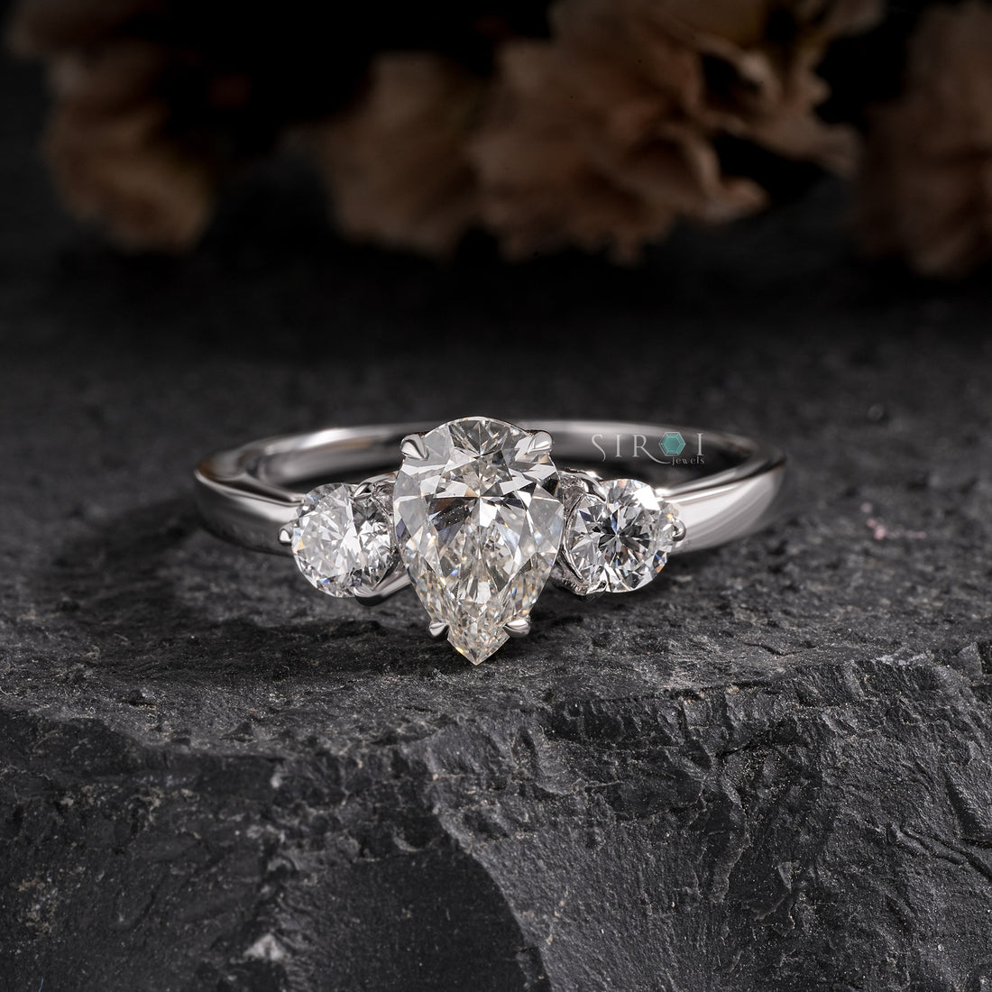 Elegant Pear and Round Three-Stone Diamond Engagement Ring in White Gold
