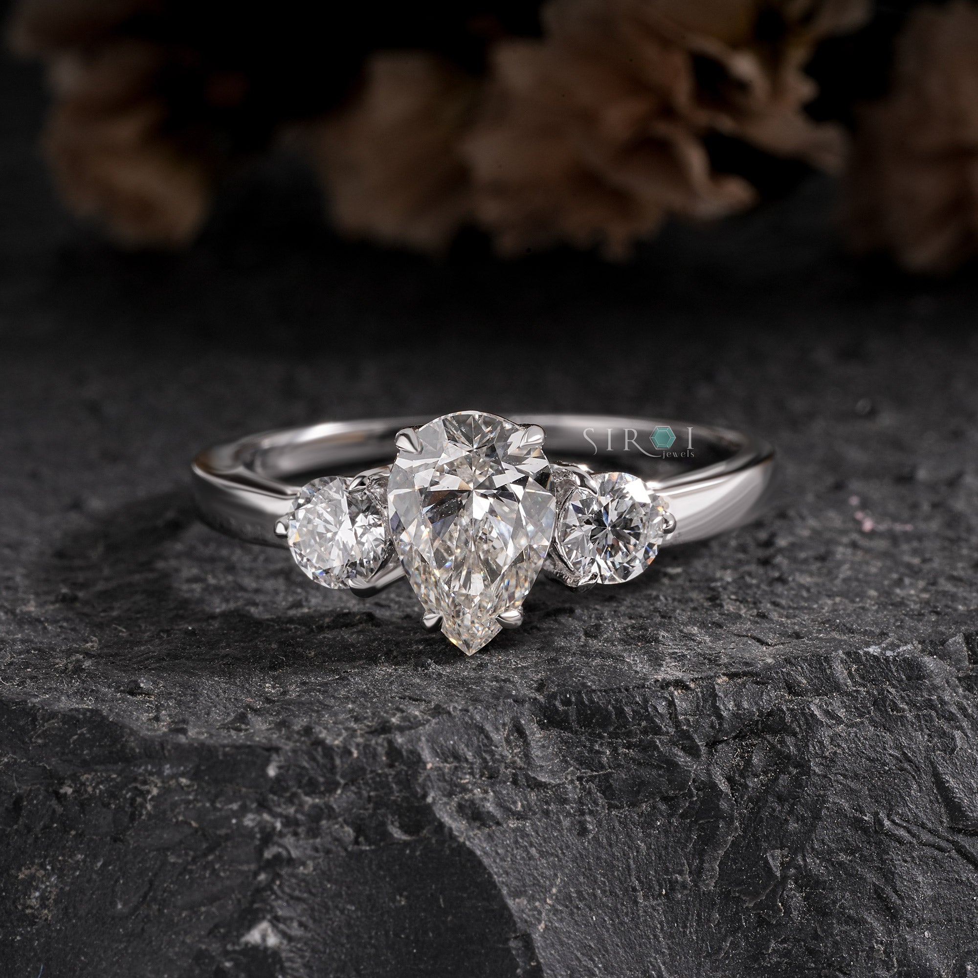 Elegant Pear and Round Three-Stone Diamond Engagement Ring in White Gold