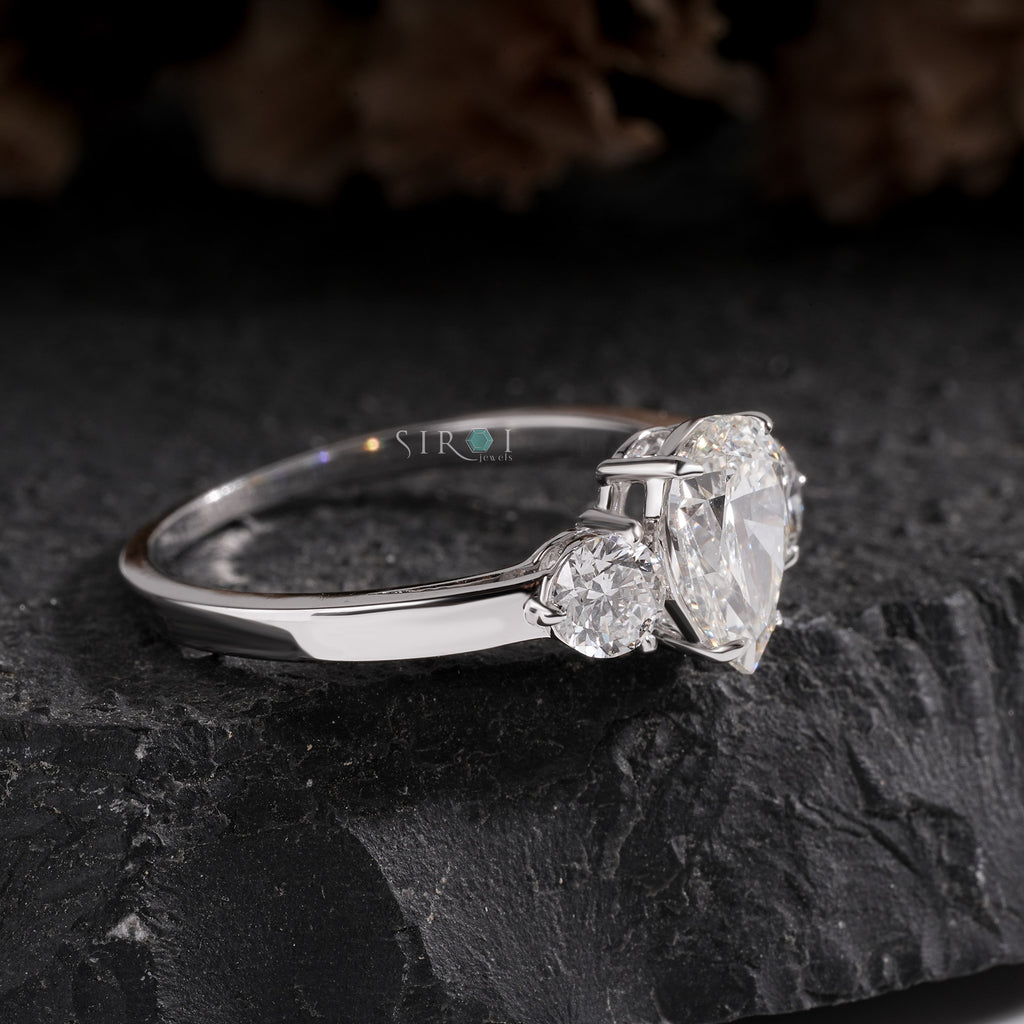 Elegant Pear and Round Three-Stone Diamond Engagement Ring in White Gold