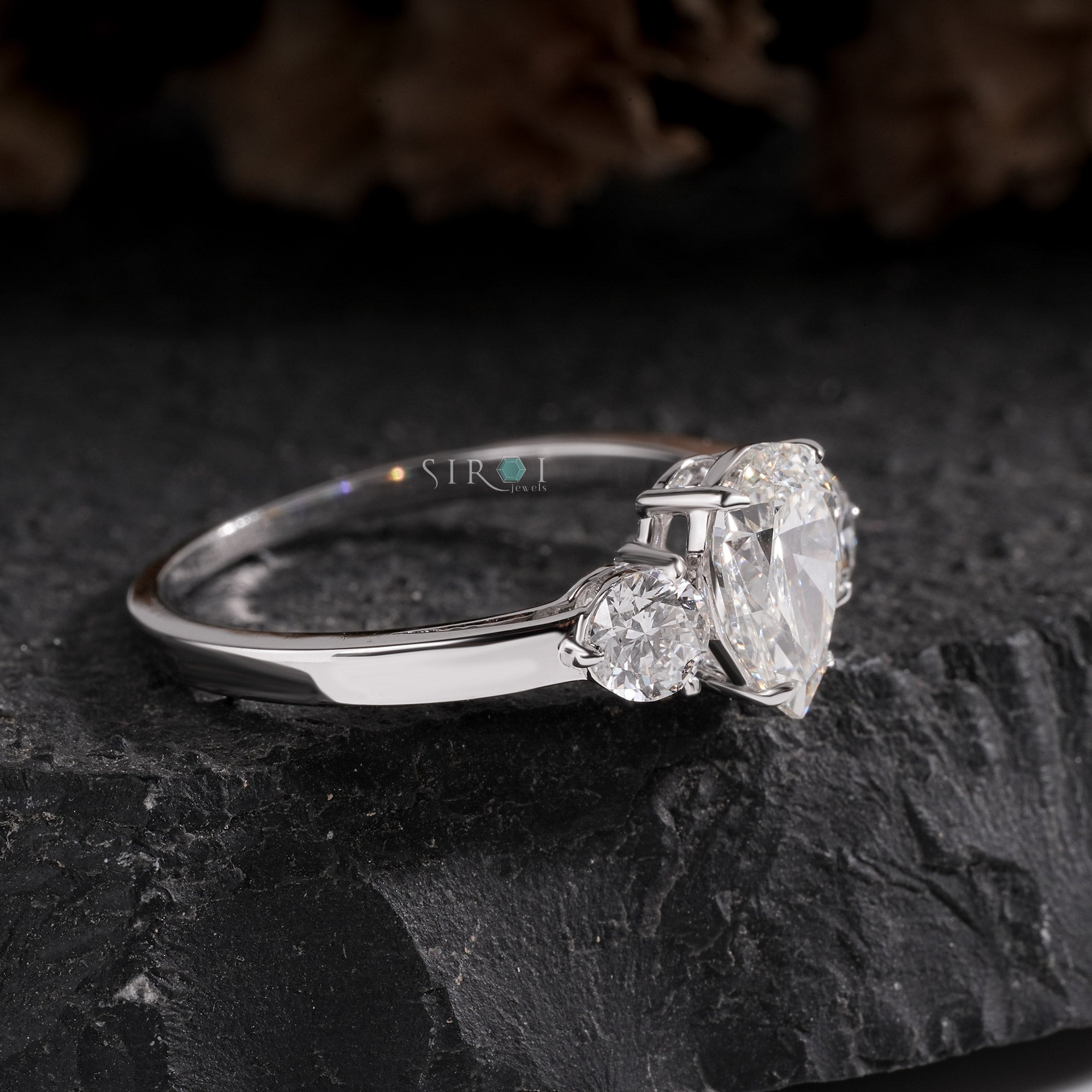 Elegant Pear and Round Three-Stone Diamond Engagement Ring in White Gold